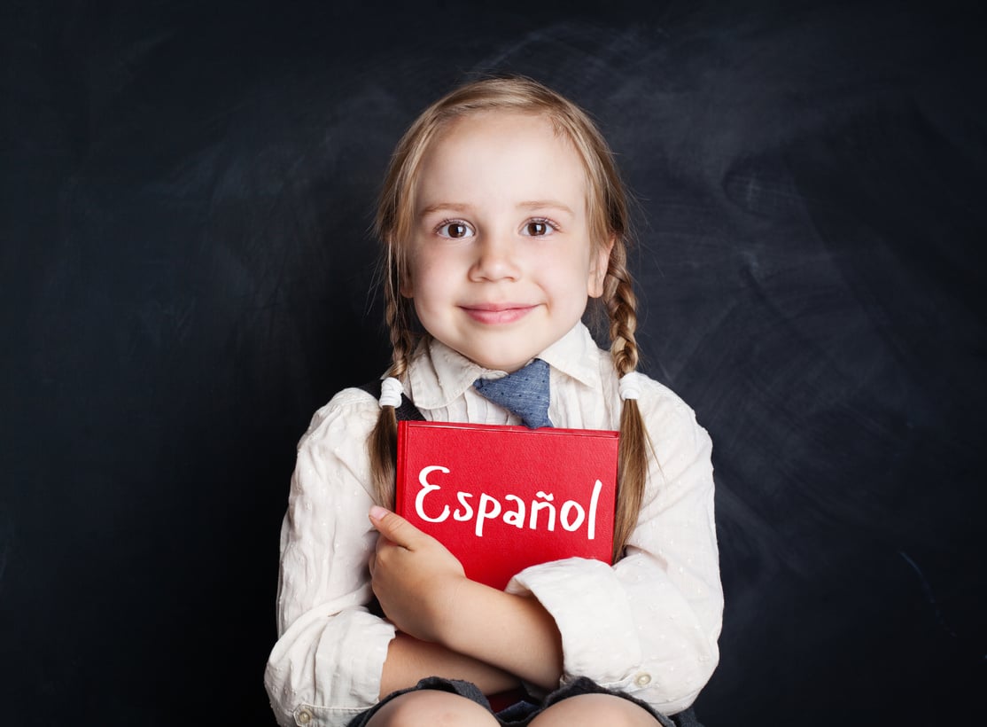 Kid learning spanish. Little girl with spanish book